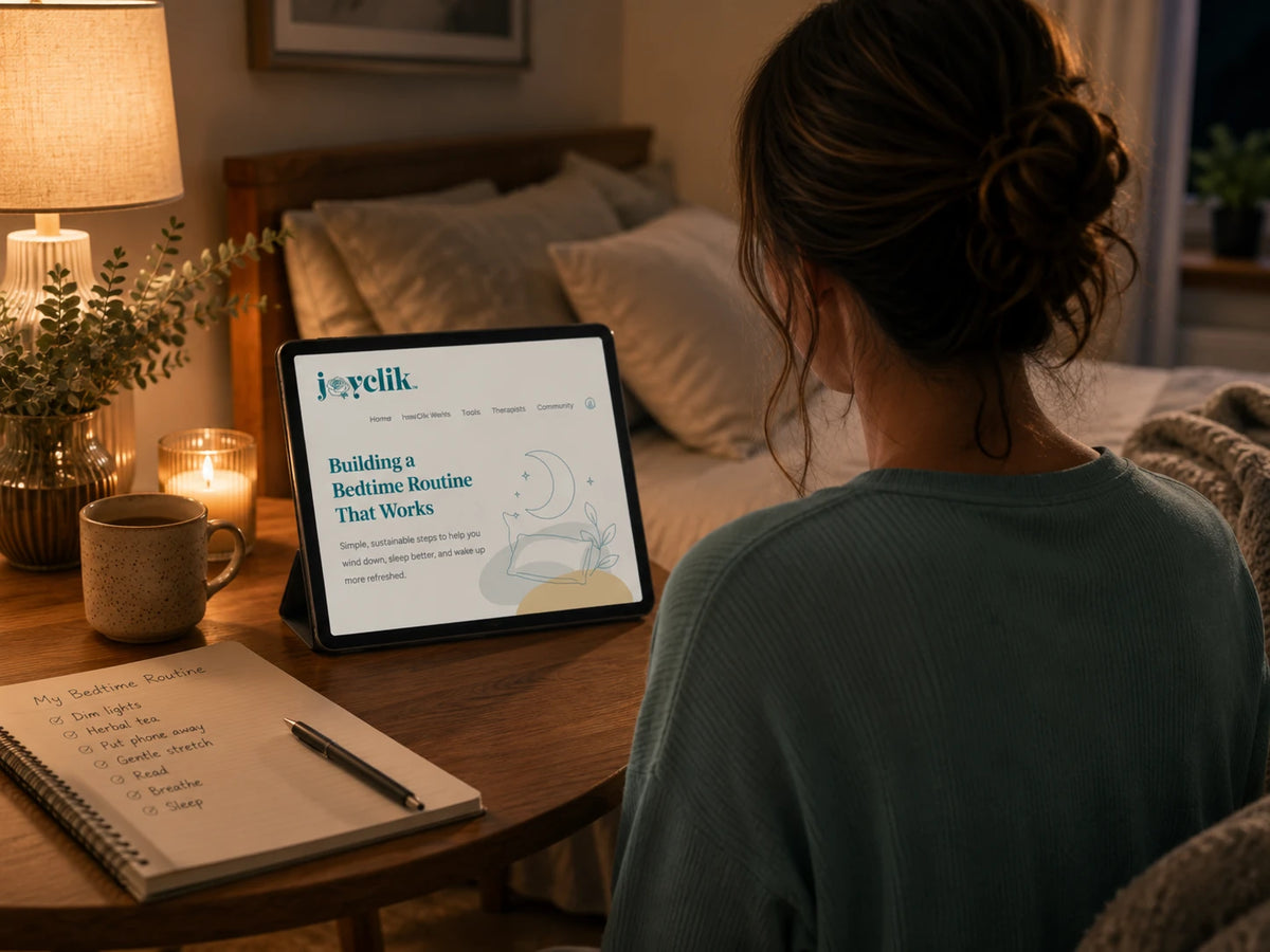 Calm JoyClik bedtime routine workspace with journal, soft evening light, and warm cup