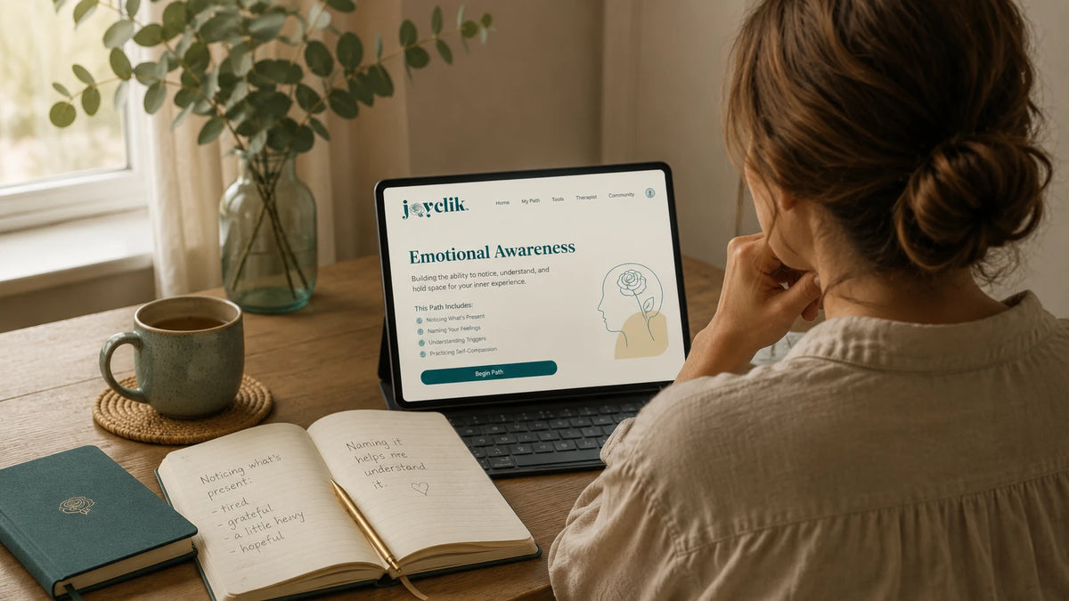 Calm JoyClik emotional awareness workspace with journal, feelings prompts, and warm natural light