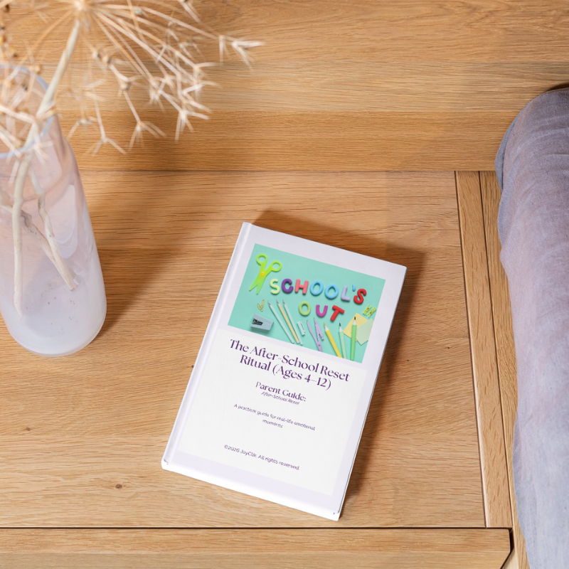 eBook titled 'School's Out' on a wooden surface with a vase of dried flowers.