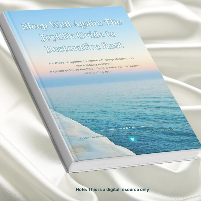 a home printed digital resource titled 'Sleep Well Again: The JoyClik Guide to Restorative Rest' on a white surface with a beach scene cover.