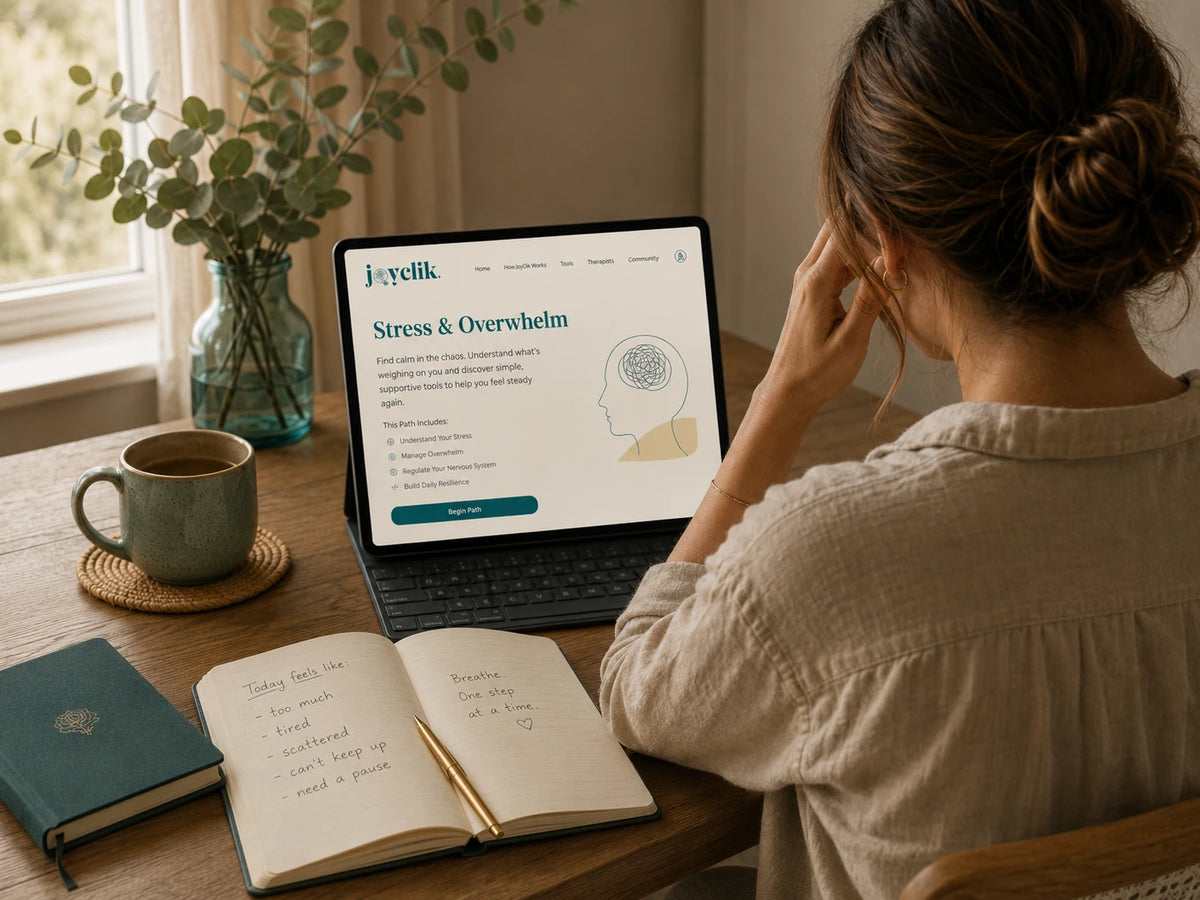 Calm JoyClik stress and overwhelm workspace with journal, laptop, and grounding tools