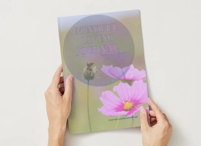 'Mindful Living Journal' held by hands on a light background