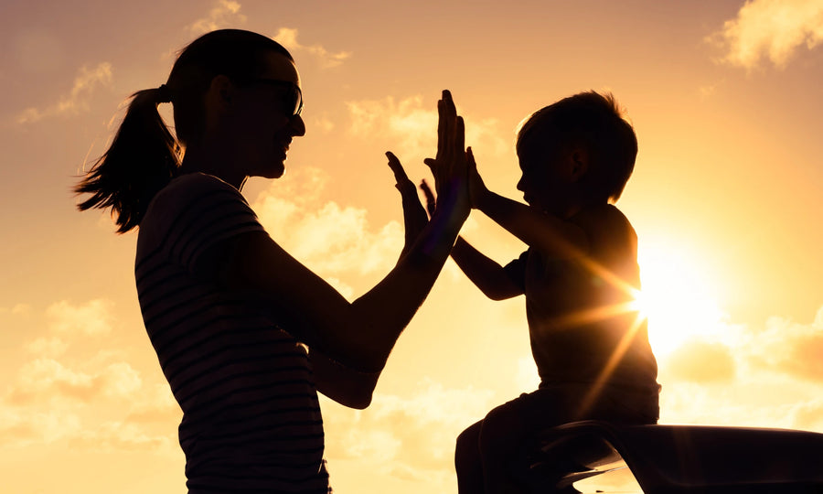 Parent and child sitting together beside a gentle reflection prompt on a tablet